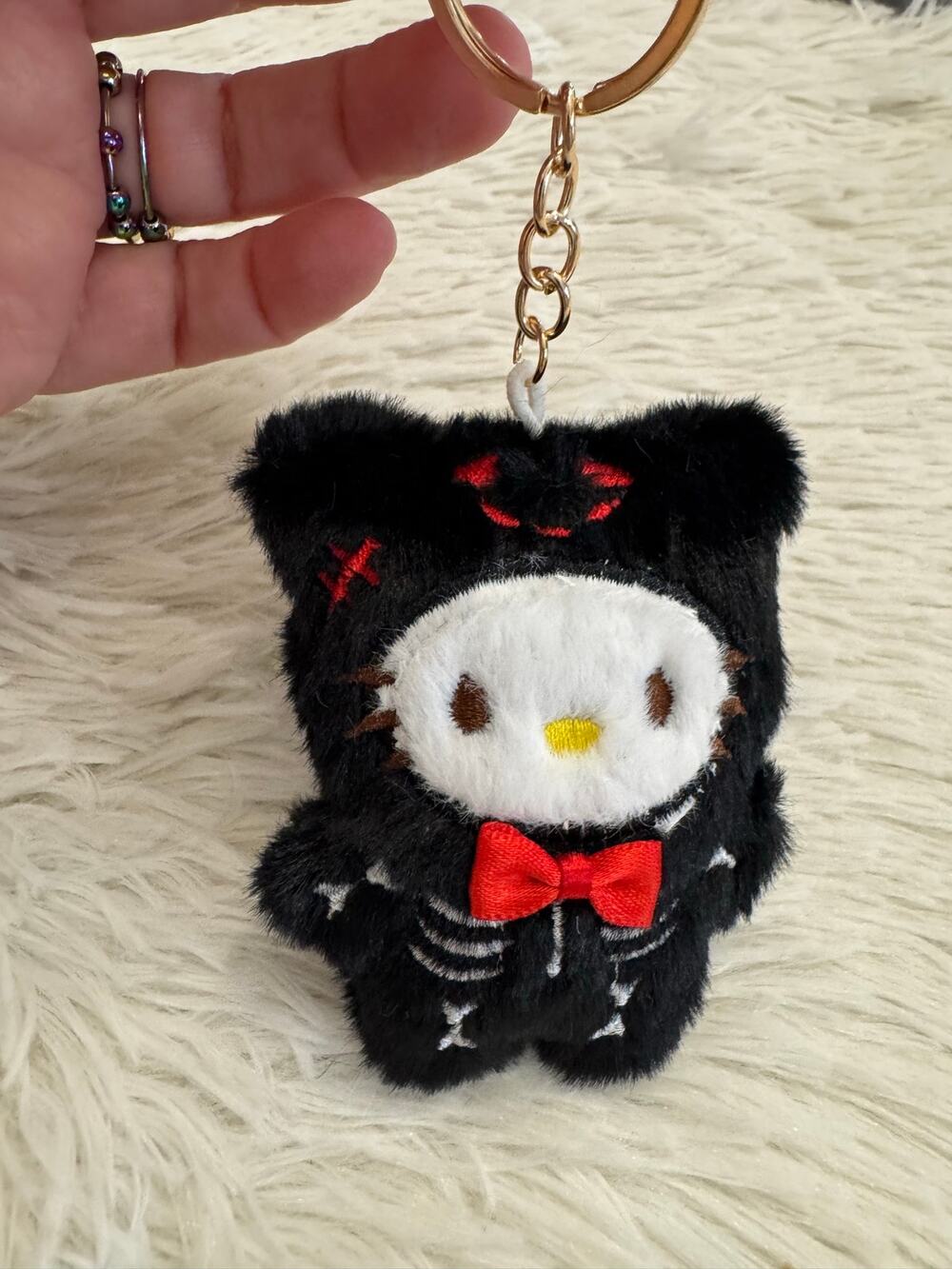 Hello Kitty Halloween plush keychain with skeleton design and red bow